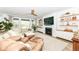Comfortable living room with cozy seating, a modern fireplace, built-in shelving, and plenty of natural light at 16283 Spring Bank Ct, Fishers, IN 46040