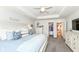Bright main bedroom with a tray ceiling, ceiling fan, and view into the walk-in closet at 16283 Spring Bank Ct, Fishers, IN 46040