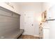 Welcoming mudroom featuring a custom bench, coat hooks, and ample storage space at 16283 Spring Bank Ct, Fishers, IN 46040
