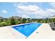 Inviting in-ground pool with basketball hoop is surrounded by a well-manicured lawn and tasteful landscaping at 16283 Spring Bank Ct, Fishers, IN 46040