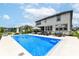 Backyard view of the sparkling in-ground pool with basketball hoop surrounded by a spacious patio and lush landscaping at 16283 Spring Bank Ct, Fishers, IN 46040