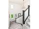 Staircase with carpeted steps, contrasting black and white banister, and natural light at 16283 Spring Bank Ct, Fishers, IN 46040