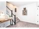 Carpeted stairs with dark railing and decor leading to the upper level of the home at 16283 Spring Bank Ct, Fishers, IN 46040