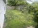 Spacious backyard with lush green lawn, surrounded by a wooden fence and mature trees at 1807 Park North Bnd, Indianapolis, IN 46260