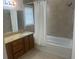 Bathroom with a window and tiled walls, featuring a shower and vanity at 1807 Park North Bnd, Indianapolis, IN 46260