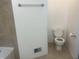 Bathroom with neutral-toned tiled walls, a white toilet, and an open vanity at 1807 Park North Bnd, Indianapolis, IN 46260