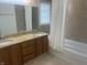 Bathroom featuring a large mirror, dual sinks, and a shower with tub at 1807 Park North Bnd, Indianapolis, IN 46260