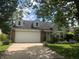 Charming single-Gathering home featuring a two-car garage, brick accents, and dormer windows at 1807 Park North Bnd, Indianapolis, IN 46260