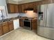 Spacious kitchen featuring a stainless steel refrigerator, oven, and classic wood cabinets at 1807 Park North Bnd, Indianapolis, IN 46260