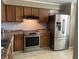 Kitchen featuring stainless steel appliances, and warm-toned wooden cabinets at 1807 Park North Bnd, Indianapolis, IN 46260