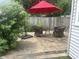 Backyard brick patio featuring outdoor seating and a red umbrella at 1807 Park North Bnd, Indianapolis, IN 46260