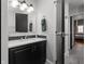 Modern bathroom featuring a vanity with black cabinets, white countertop, and stylish backsplash, offering a contemporary design at 207 S Meridian St # 2F, Indianapolis, IN 46225