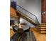 Dining area features a round table, contemporary chairs, a staircase and exposed brick accents at 207 S Meridian St # 2F, Indianapolis, IN 46225