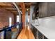 Modern kitchenette with stainless steel appliances, sleek cabinetry, and hardwood flooring at 207 S Meridian St # 2F, Indianapolis, IN 46225