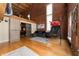 Spacious living room boasts high ceilings, exposed brick, hardwood floors, and a comfortable gray sectional at 207 S Meridian St # 2F, Indianapolis, IN 46225