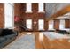 This living room shows high ceilings, exposed brick, hardwood floors and comfortable gray sectional at 207 S Meridian St # 2F, Indianapolis, IN 46225