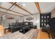 Spacious living room with comfortable sofa and wooden beam ceilings with hardwood floors at 207 S Meridian St # 2F, Indianapolis, IN 46225