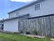 Fenced backyard with well-maintained grass and an exterior view of the house at 2080 Miracle Dr, Columbus, IN 47201