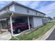 Exterior view showcasing a covered carport area with a red car parked inside at 2080 Miracle Dr, Columbus, IN 47201