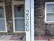 Close up of the house number '2080' displayed on a brick facade at 2080 Miracle Dr, Columbus, IN 47201