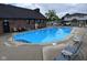Bright blue community pool surrounded by lounge chairs and a well-maintained patio area at 2080 Miracle Dr, Columbus, IN 47201
