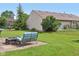The backyard features lush grass, mature trees, and comfortable lounge furniture at 2127 Yosemite Dr, Lebanon, IN 46052
