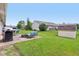 View of backyard with patio seating area, grill, shed, and well-manicured lawn at 2127 Yosemite Dr, Lebanon, IN 46052