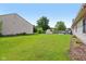 Wide shot of a large green backyard with storage shed and patio set at 2127 Yosemite Dr, Lebanon, IN 46052