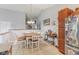 Bright dining area with wood table, seating for six, and view to the kitchen and hall at 2127 Yosemite Dr, Lebanon, IN 46052