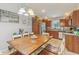 Bright dining area featuring a large wooden table, white chairs, and views into the kitchen, great for Gathering gatherings at 2127 Yosemite Dr, Lebanon, IN 46052