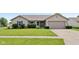 Charming single-story home featuring blue shutters, well-manicured lawn, and an attached two car garage at 2127 Yosemite Dr, Lebanon, IN 46052