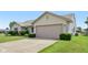 View of a single-story home's side profile, showcasing a well-maintained lawn and an attached two car garage at 2127 Yosemite Dr, Lebanon, IN 46052