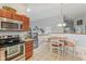 Kitchen with stainless steel appliances and plenty of wooden cabinetry, next to the dining area at 2127 Yosemite Dr, Lebanon, IN 46052