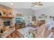 Comfortable living room featuring a brick fireplace, hardwood floors, and a ceiling fan, perfect for relaxing at 2127 Yosemite Dr, Lebanon, IN 46052