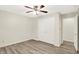 Neutral bedroom with ceiling fan, closet, and wood-look flooring at 248 Eastview Dr, Bargersville, IN 46106