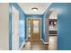 Inviting entryway featuring wood-look floors, light brown front door and light-filled archway to the kitchen at 248 Eastview Dr, Bargersville, IN 46106