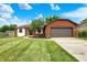 Charming single-story home with brick and siding, a well-manicured lawn and an attached two car garage at 248 Eastview Dr, Bargersville, IN 46106