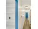 Hallway featuring wood laminate flooring, white walls, blue accent wall, and recessed lighting at 248 Eastview Dr, Bargersville, IN 46106