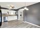 Kitchen featuring stainless steel appliances, white cabinets, gray tile backsplash, wood laminate flooring, and gray walls at 248 Eastview Dr, Bargersville, IN 46106