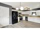 A kitchen featuring stainless steel appliances, white cabinets, gray tile backsplash, wood laminate floors, and gray walls at 248 Eastview Dr, Bargersville, IN 46106