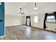 Living room with laminate flooring, ceiling fans, and view of yard from windows at 248 Eastview Dr, Bargersville, IN 46106
