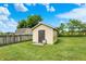 Backyard shed with a fenced perimeter and green grass at 248 Eastview Dr, Bargersville, IN 46106