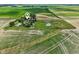 Expansive aerial view of country home surrounded by farmland with separate guest house at 26735 Six Points Rd, Sheridan, IN 46069