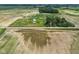 Aerial view of country property with a charming home, grassy yard, and bordering farm fields at 26735 Six Points Rd, Sheridan, IN 46069