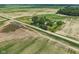 Expansive aerial view of a charming property surrounded by lush agricultural fields at 26735 Six Points Rd, Sheridan, IN 46069