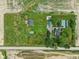 Aerial view showcases the property layout with outbuildings, landscaping, and surrounding green space at 26735 Six Points Rd, Sheridan, IN 46069
