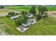 Aerial view of country property with a charming home, RV, large yard, and outbuildings at 26735 Six Points Rd, Sheridan, IN 46069