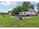 Scenic backyard with a fire pit, seating, and recreational vehicle, offering a perfect blend of relaxation and adventure at 26735 Six Points Rd, Sheridan, IN 46069