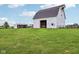 Expansive white barn with a glimpse of the interior, ideal for agricultural pursuits and property enhancement at 26735 Six Points Rd, Sheridan, IN 46069