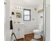 Bathroom with a wooden-framed window above the sink and a wooden floor at 26735 Six Points Rd, Sheridan, IN 46069